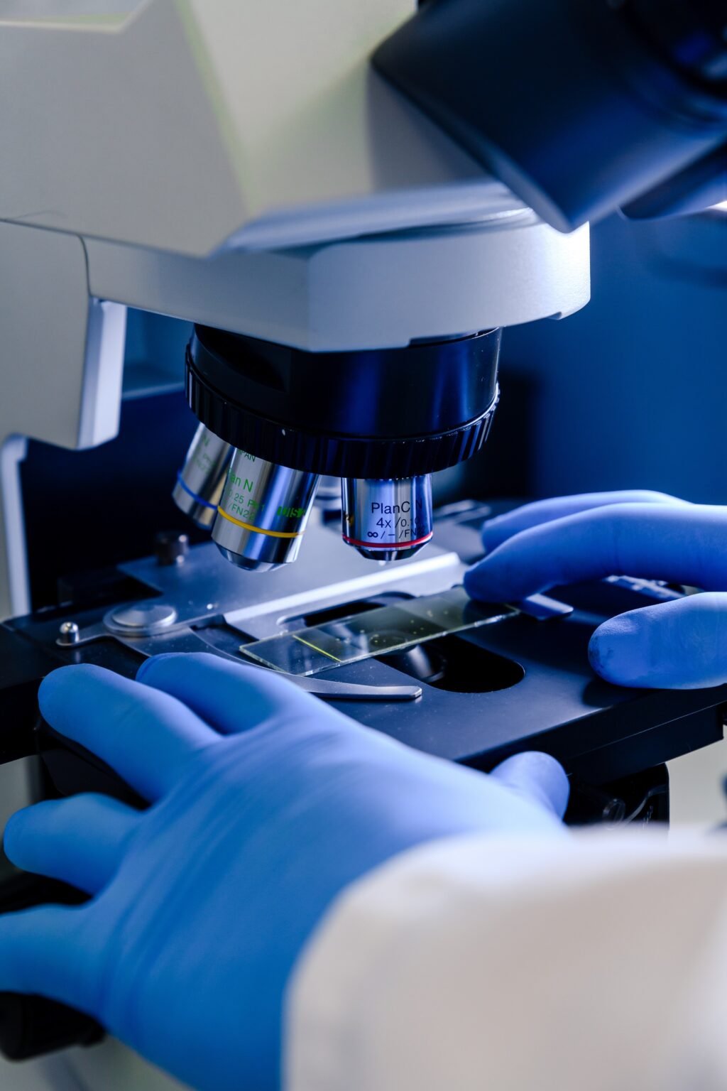 A laboratory worker working with a modern microscope while conducting a coronavirus research